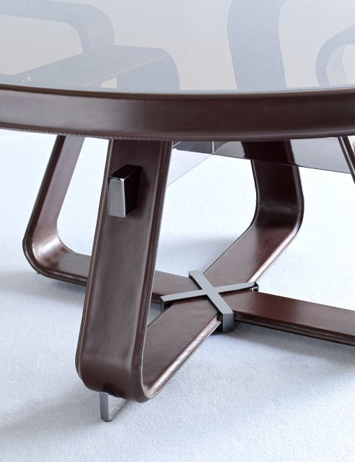 Round table with bronzed glass top and base covered in brown leather. Online sales, free home delivery.