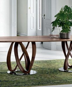 Elliptical table with top in solid canaletto walnut. Large oval top. Chromed metal legs. Design Stefano Bigi. Free delivery.