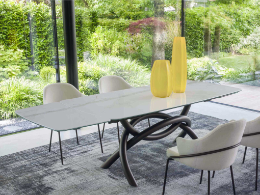 Extendable table. Sculptural metal base. Glass and ceramic top. Made in Italy and customizable. Buy quality tables with free delivery.