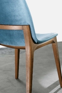 Dettaglio di sedia di design italiana con struttura in legno massello e rivestimento in tessuto