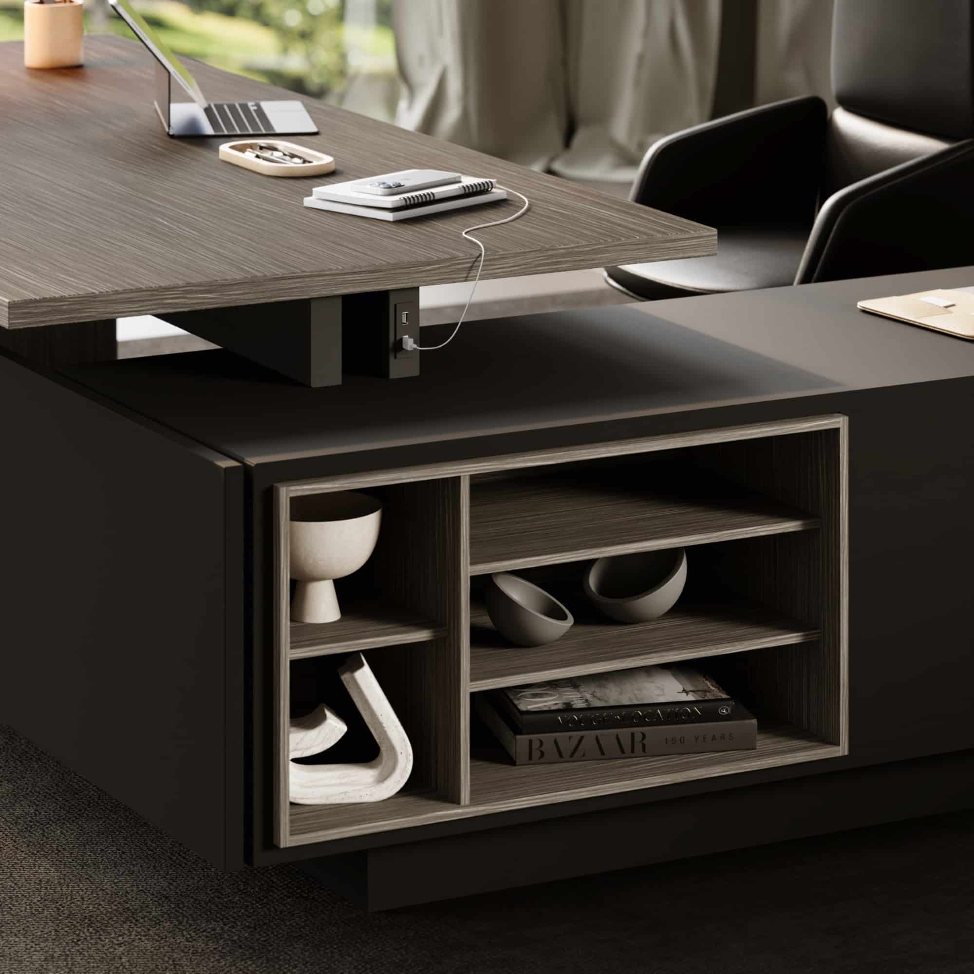 Close-up of the open compartments in the Elite desk’s black storage return.
