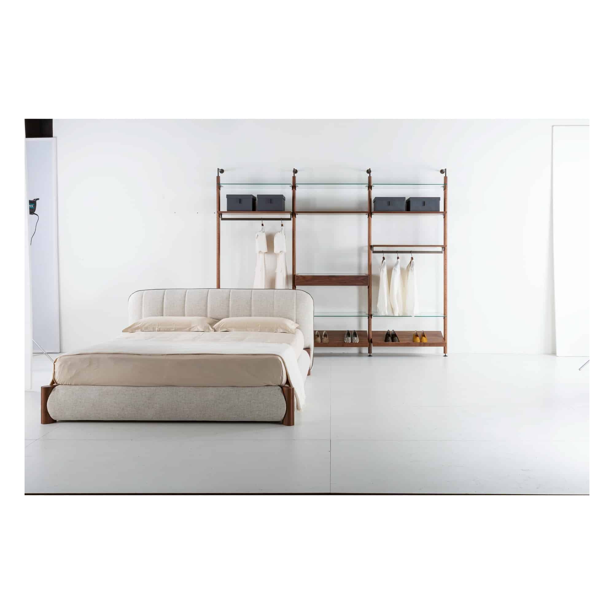Nuage upholstered bed in a bedroom with an open walk-in wardrobe